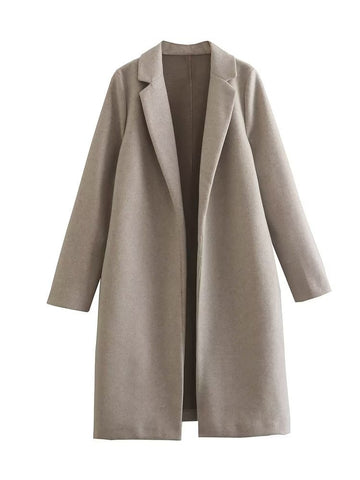 Elegant woolen overcoat paired with a vintage cardigan for timeless winter styling.