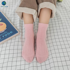 Colorful multi-colored autumn socks displayed together, showcasing warmth and style for the fall season.
