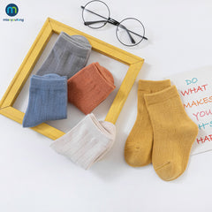 Colorful multi-colored autumn socks displayed together, showcasing warmth and style for the fall season.