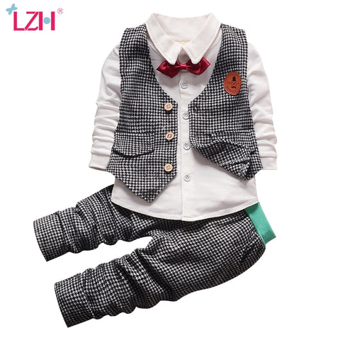 Stylish children's clothing displayed on hangers in a boutique, showcasing vibrant colors and trendy designs.