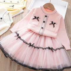 Elegant winter sweater paired with a stylish tulle dress, perfect for seasonal fashion ensembles.
