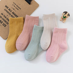 Colorful multi-colored autumn socks displayed together, showcasing warmth and style for the fall season.