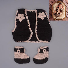 Newborn photography showcasing an adorable infant in a cowboy crochet outfit, capturing sweet moments.