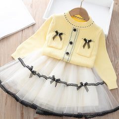 Elegant winter sweater paired with a stylish tulle dress, perfect for seasonal fashion ensembles.