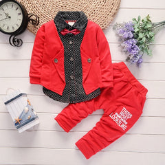 Stylish children's clothing displayed on hangers in a boutique, showcasing vibrant colors and trendy designs.