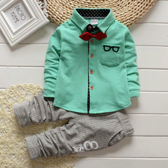 Stylish children's clothing displayed on hangers in a boutique, showcasing vibrant colors and trendy designs.