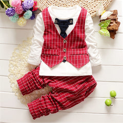 Stylish children's clothing displayed on hangers in a boutique, showcasing vibrant colors and trendy designs.