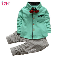 Stylish children's clothing displayed on hangers in a boutique, showcasing vibrant colors and trendy designs.