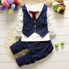 Stylish children's clothing displayed on hangers in a boutique, showcasing vibrant colors and trendy designs.