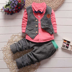 Stylish children's clothing displayed on hangers in a boutique, showcasing vibrant colors and trendy designs.