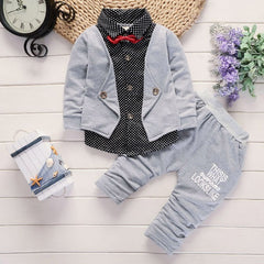 Stylish children's clothing displayed on hangers in a boutique, showcasing vibrant colors and trendy designs.