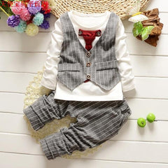 Stylish children's clothing displayed on hangers in a boutique, showcasing vibrant colors and trendy designs.