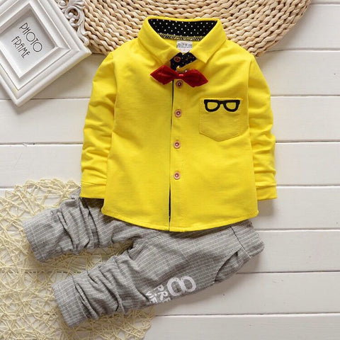 Stylish children's clothing displayed on hangers in a boutique, showcasing vibrant colors and trendy designs.