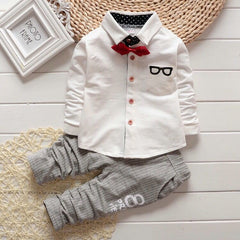 Stylish children's clothing displayed on hangers in a boutique, showcasing vibrant colors and trendy designs.