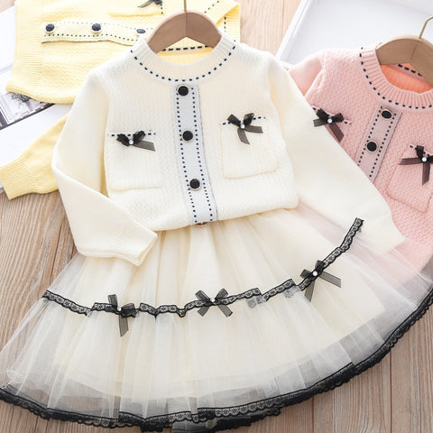 Elegant winter sweater paired with a stylish tulle dress, perfect for seasonal fashion ensembles.