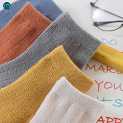 Colorful multi-colored autumn socks displayed together, showcasing warmth and style for the fall season.