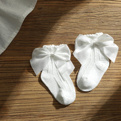 Knee high classy formal dress featuring a big bow, perfect for elegant occasions and sophisticated events.