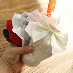 Knee high classy formal dress featuring a big bow, perfect for elegant occasions and sophisticated events.