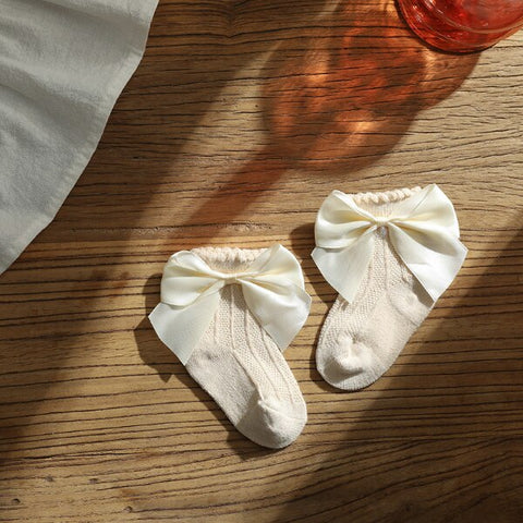 Knee high classy formal dress featuring a big bow, perfect for elegant occasions and sophisticated events.