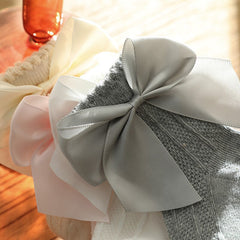Knee high classy formal dress featuring a big bow, perfect for elegant occasions and sophisticated events.