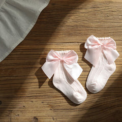 Knee high classy formal dress featuring a big bow, perfect for elegant occasions and sophisticated events.