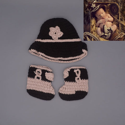 Newborn photography showcasing an adorable infant in a cowboy crochet outfit, capturing sweet moments.