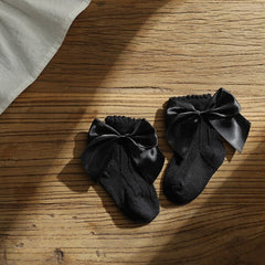 Knee high classy formal dress featuring a big bow, perfect for elegant occasions and sophisticated events.