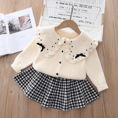 Elegant winter sweater paired with a stylish tulle dress, perfect for seasonal fashion ensembles.