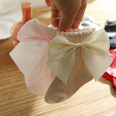 Knee high classy formal dress featuring a big bow, perfect for elegant occasions and sophisticated events.